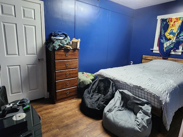 bedroom with wood-type flooring