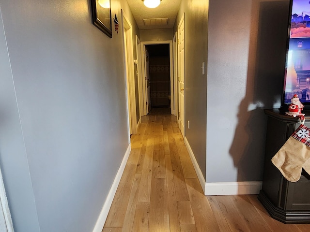 hall with light wood-type flooring