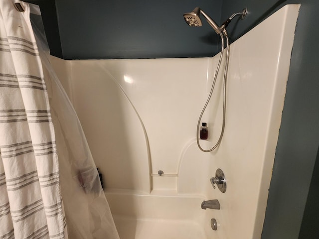 bathroom with shower / bath combo with shower curtain