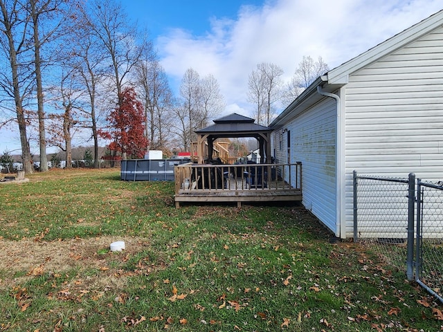 view of yard with a gazebo and a pool side deck