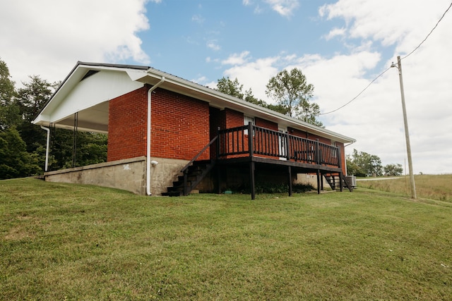 back of house featuring a yard and a wooden deck