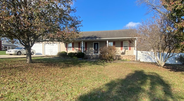 ranch-style house featuring covered porch, a garage, and a front lawn