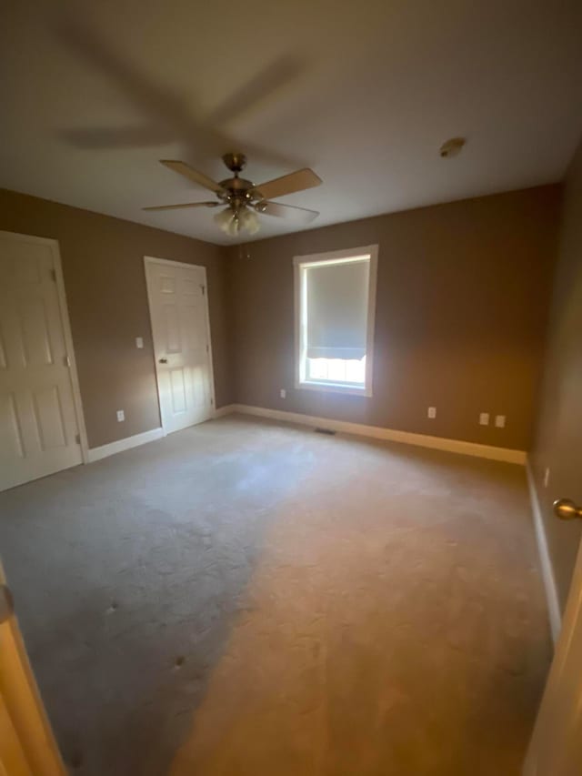 carpeted empty room with ceiling fan