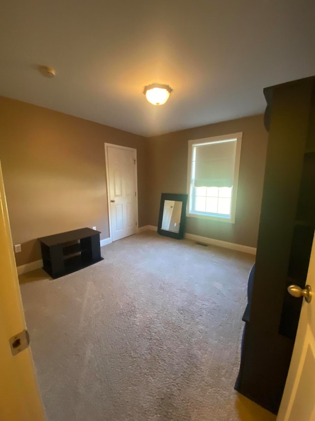 unfurnished living room featuring carpet