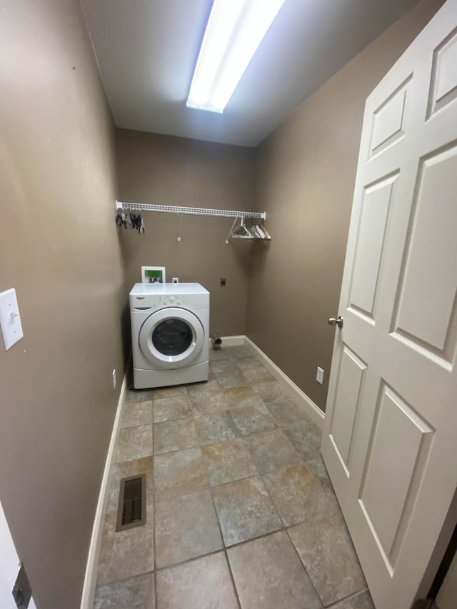 clothes washing area featuring washer / dryer