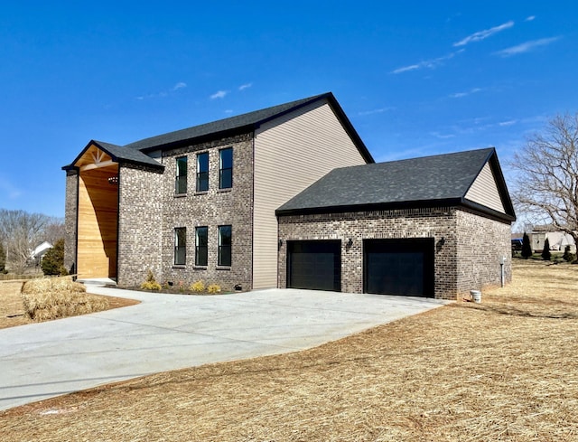 view of front of home with driveway, brick siding, and an attached garage