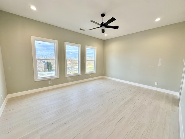 spare room featuring light wood-style flooring, recessed lighting, baseboards, and ceiling fan