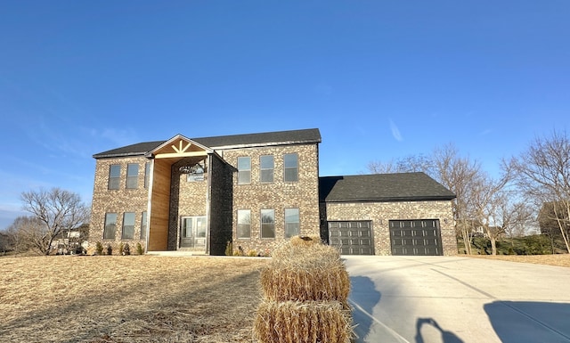 view of front of property with brick siding, a garage, and driveway