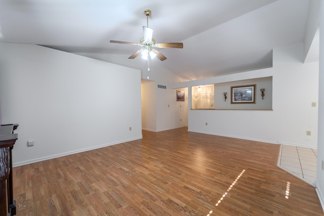 unfurnished living room with ceiling fan, vaulted ceiling, and hardwood / wood-style flooring