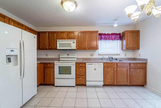 kitchen featuring sink, light tile patterned floors, white appliances, and an inviting chandelier