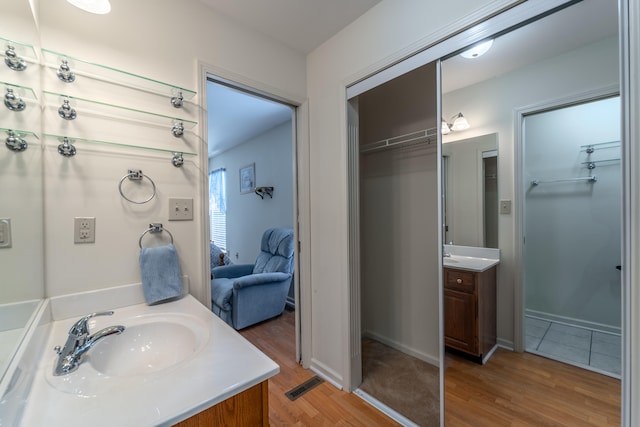 bathroom with vanity and wood-type flooring