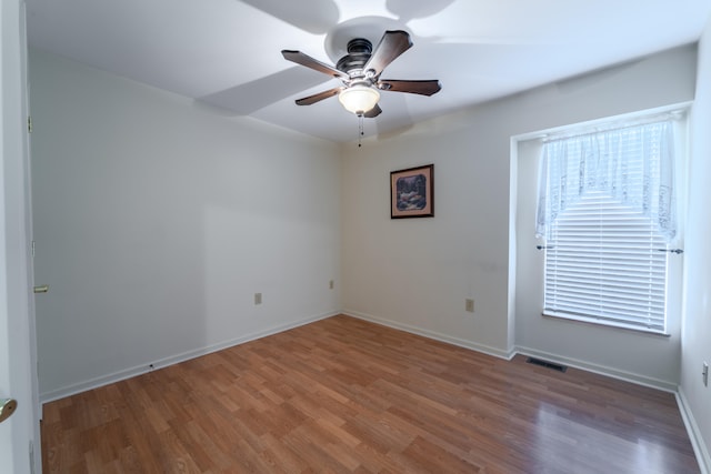 spare room with ceiling fan and dark hardwood / wood-style floors