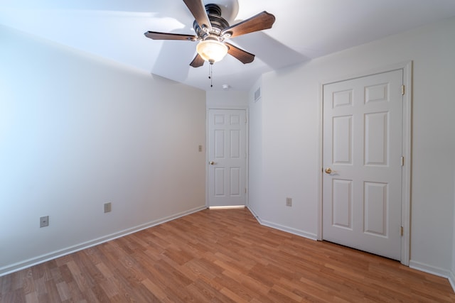 unfurnished bedroom featuring ceiling fan and light wood-type flooring