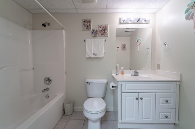 full bathroom with a drop ceiling, tile patterned floors, shower / bathing tub combination, toilet, and vanity