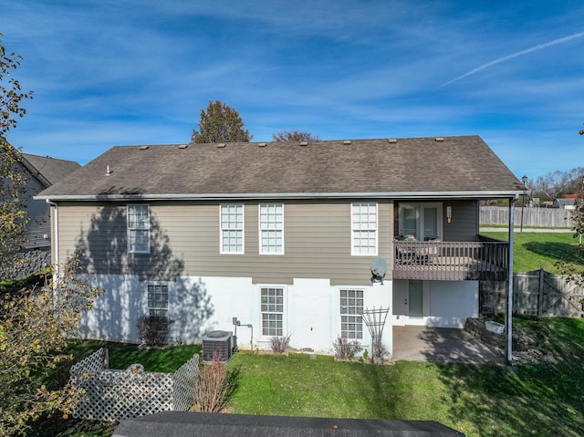 back of property featuring a patio, central AC, and a lawn