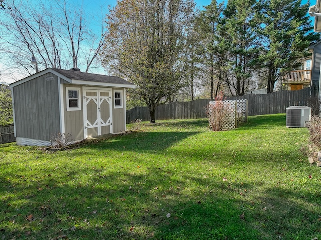 view of yard with cooling unit and a storage shed