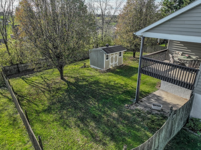 view of yard featuring a deck and a storage unit