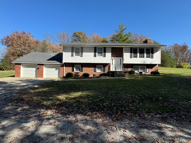 raised ranch with a front lawn and a garage