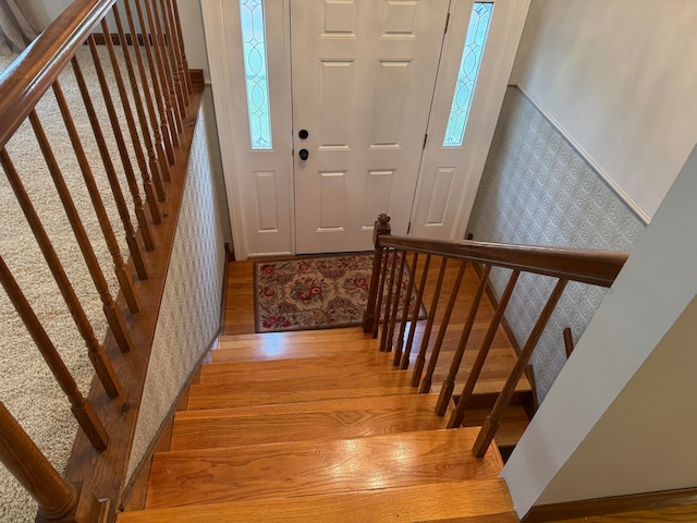 foyer entrance featuring light wood-type flooring and a healthy amount of sunlight