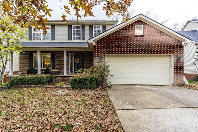 front of property featuring a porch and a garage