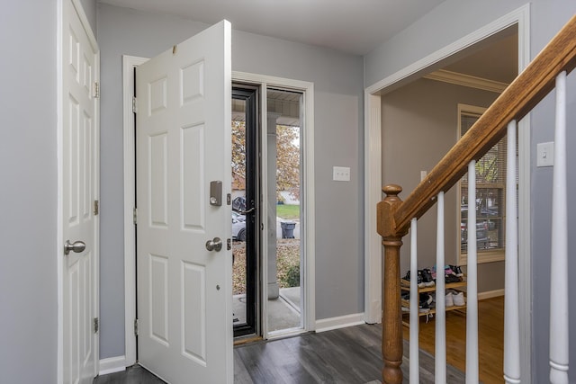 entrance foyer featuring dark hardwood / wood-style floors and crown molding