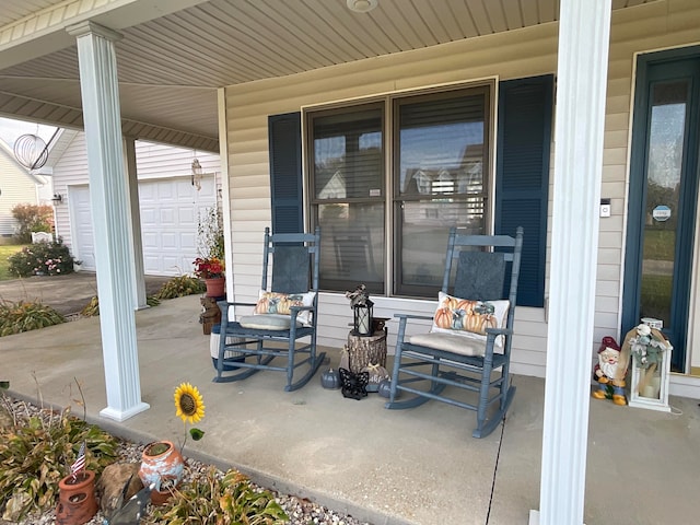 view of patio / terrace featuring a porch and a garage