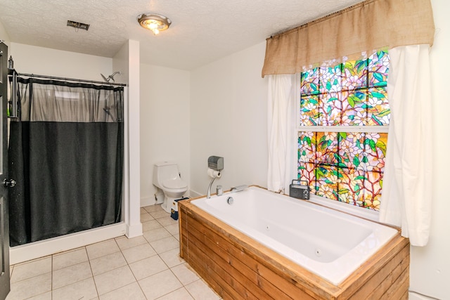 bathroom featuring shower with separate bathtub, tile patterned flooring, a textured ceiling, and toilet