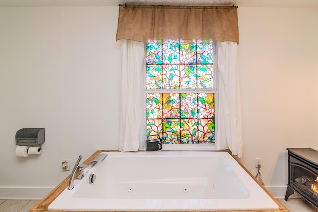 bathroom with tile patterned floors and a bathtub