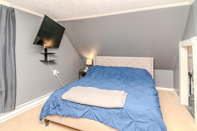 bedroom with a textured ceiling, ornamental molding, carpet floors, and vaulted ceiling