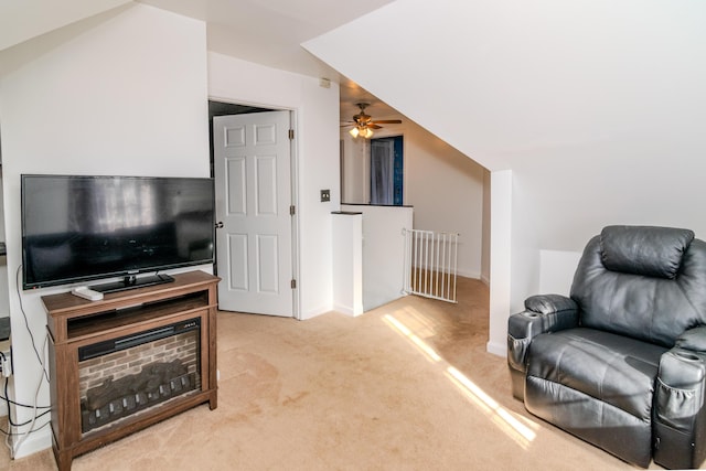 living room with carpet flooring, ceiling fan, and vaulted ceiling