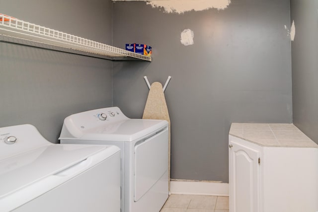 laundry room featuring light tile patterned floors and washer and clothes dryer