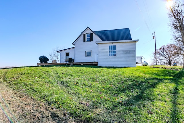 rear view of property with a lawn and a wooden deck