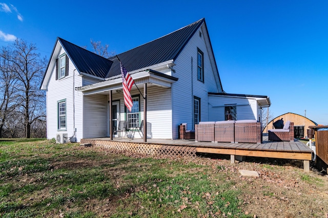 back of property featuring a lawn and an outdoor living space