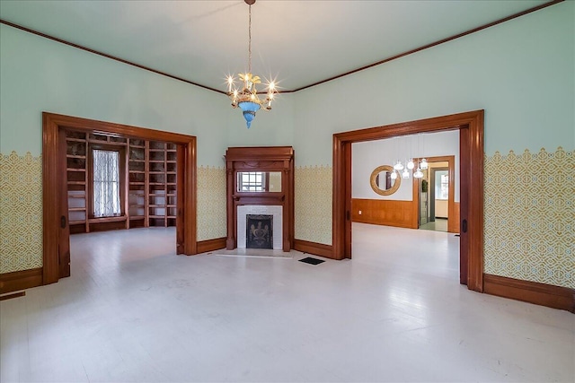 unfurnished living room with concrete flooring and an inviting chandelier