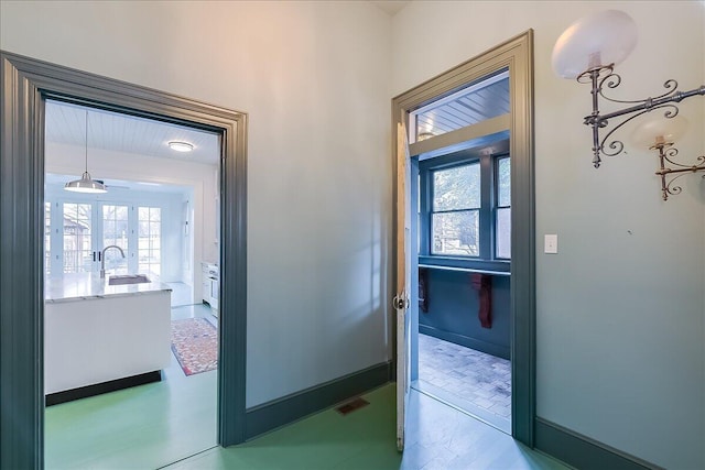 doorway featuring a wealth of natural light and sink