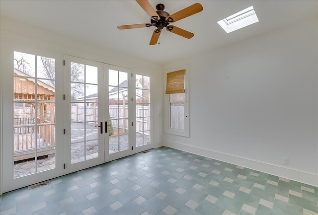 doorway featuring a skylight, ceiling fan, and french doors