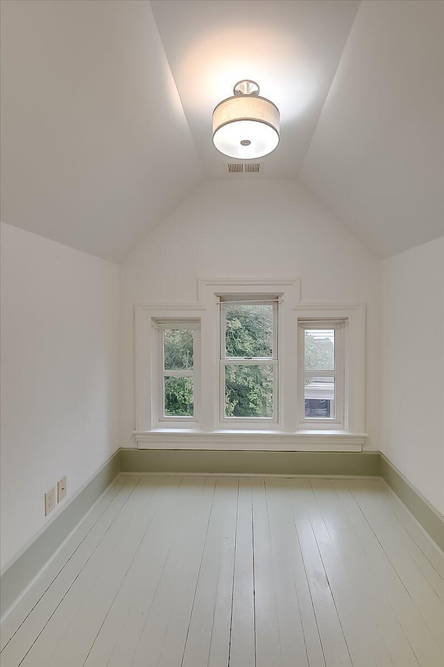 bonus room with light hardwood / wood-style flooring and vaulted ceiling