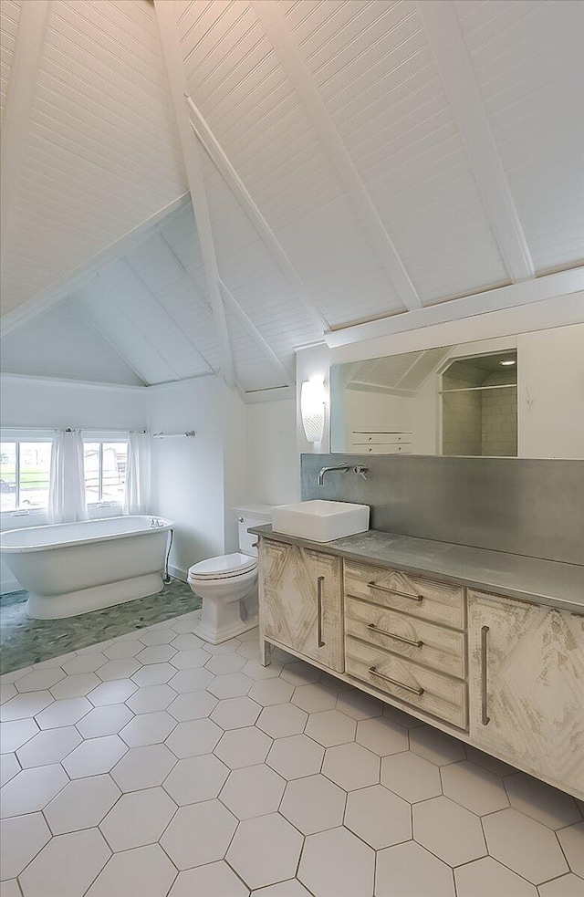 bathroom with vanity, tile patterned flooring, vaulted ceiling with beams, toilet, and a bathing tub