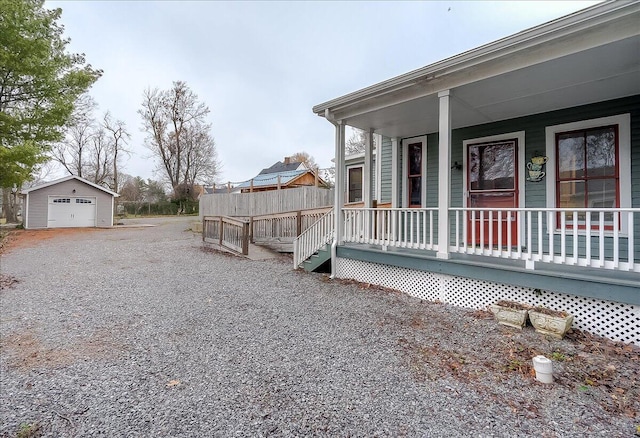 view of home's exterior with an outbuilding and a porch