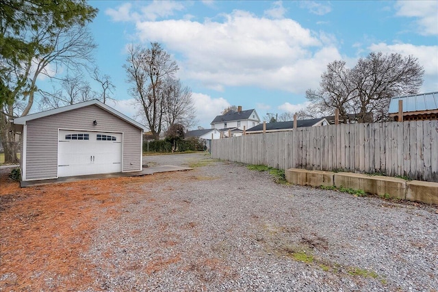 view of yard featuring a garage and an outdoor structure