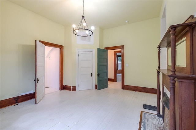 interior space with a notable chandelier and light hardwood / wood-style floors