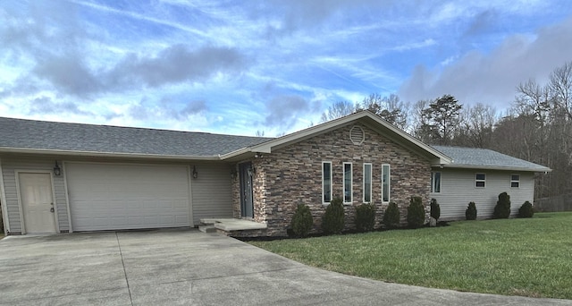 ranch-style house featuring a front yard and a garage