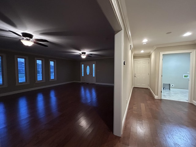 empty room featuring ornamental molding and dark hardwood / wood-style floors