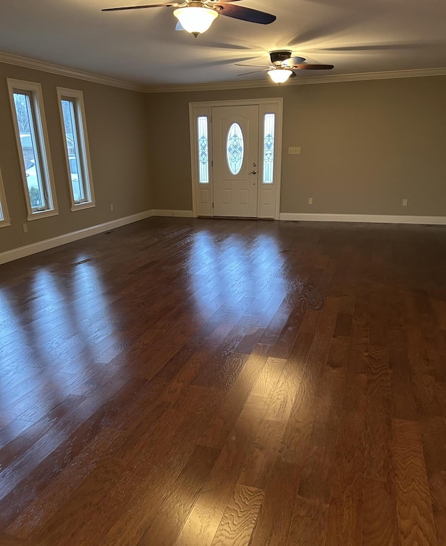 foyer entrance featuring ceiling fan, dark wood-type flooring, and ornamental molding