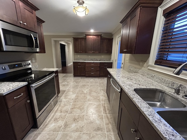 kitchen with light stone countertops, stainless steel appliances, ornamental molding, and sink