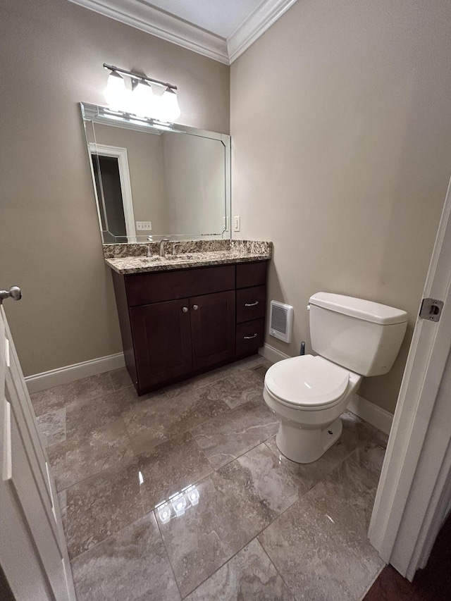 bathroom featuring toilet, ornamental molding, and vanity