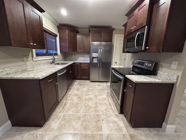 kitchen featuring light tile patterned floors, stainless steel appliances, light stone counters, and sink