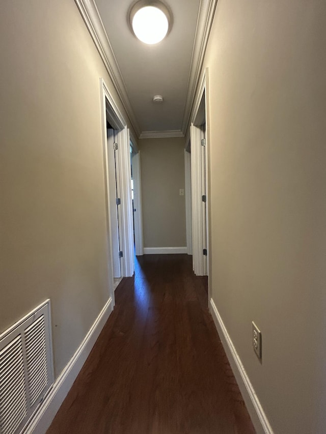 corridor featuring dark hardwood / wood-style flooring and crown molding