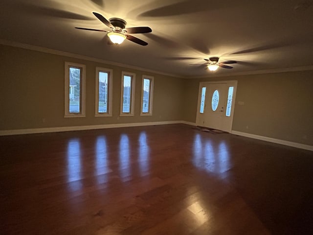 interior space with ornamental molding and dark hardwood / wood-style flooring