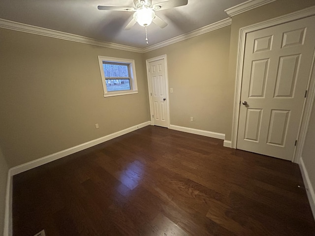 unfurnished bedroom featuring ceiling fan, dark hardwood / wood-style flooring, and crown molding